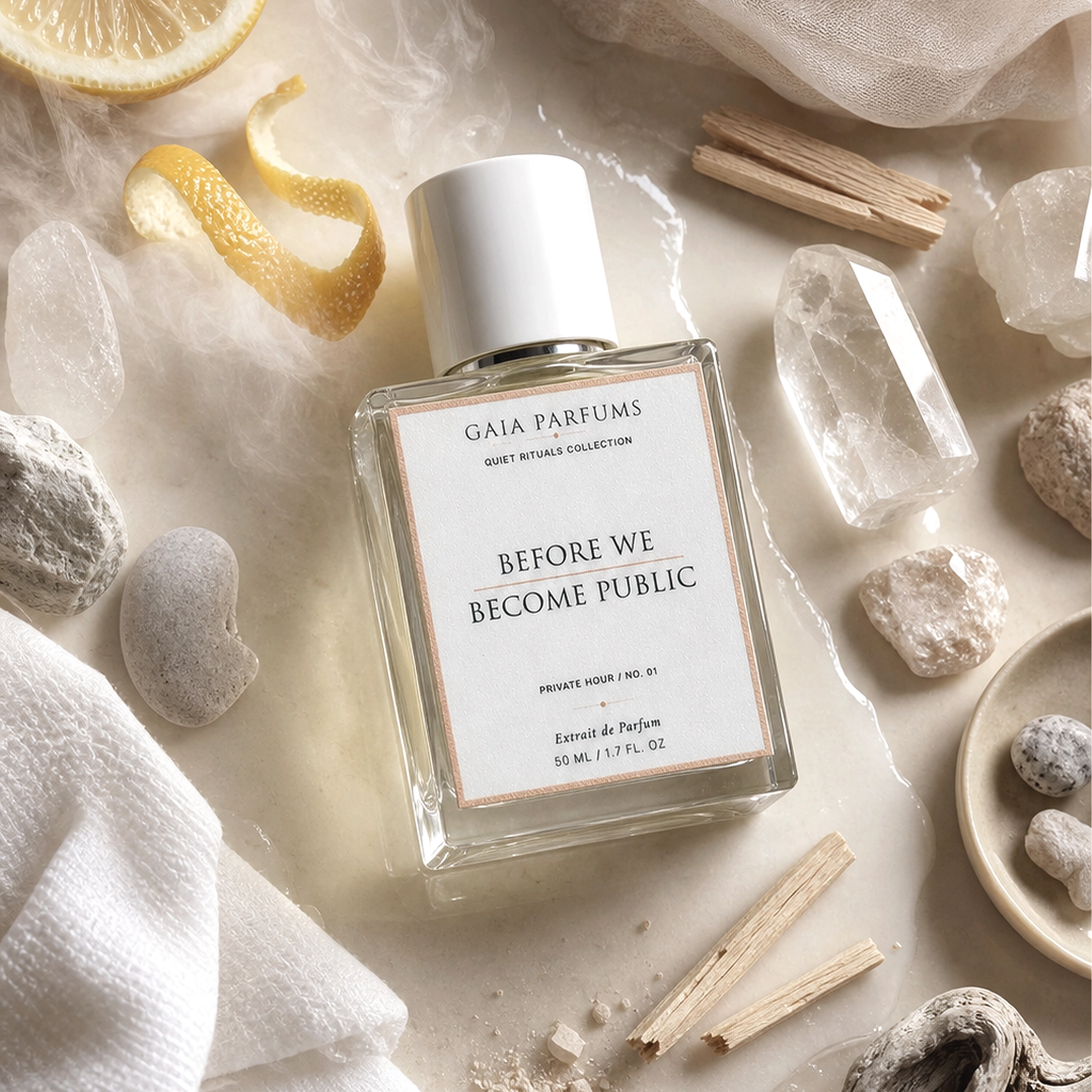 Gaia Parfums perfume bottle with natural elements on a light background. GAIA Parfums Before We Become Public unisex Eau de Parfum with fresh skin, mineral air, and sheer woods.