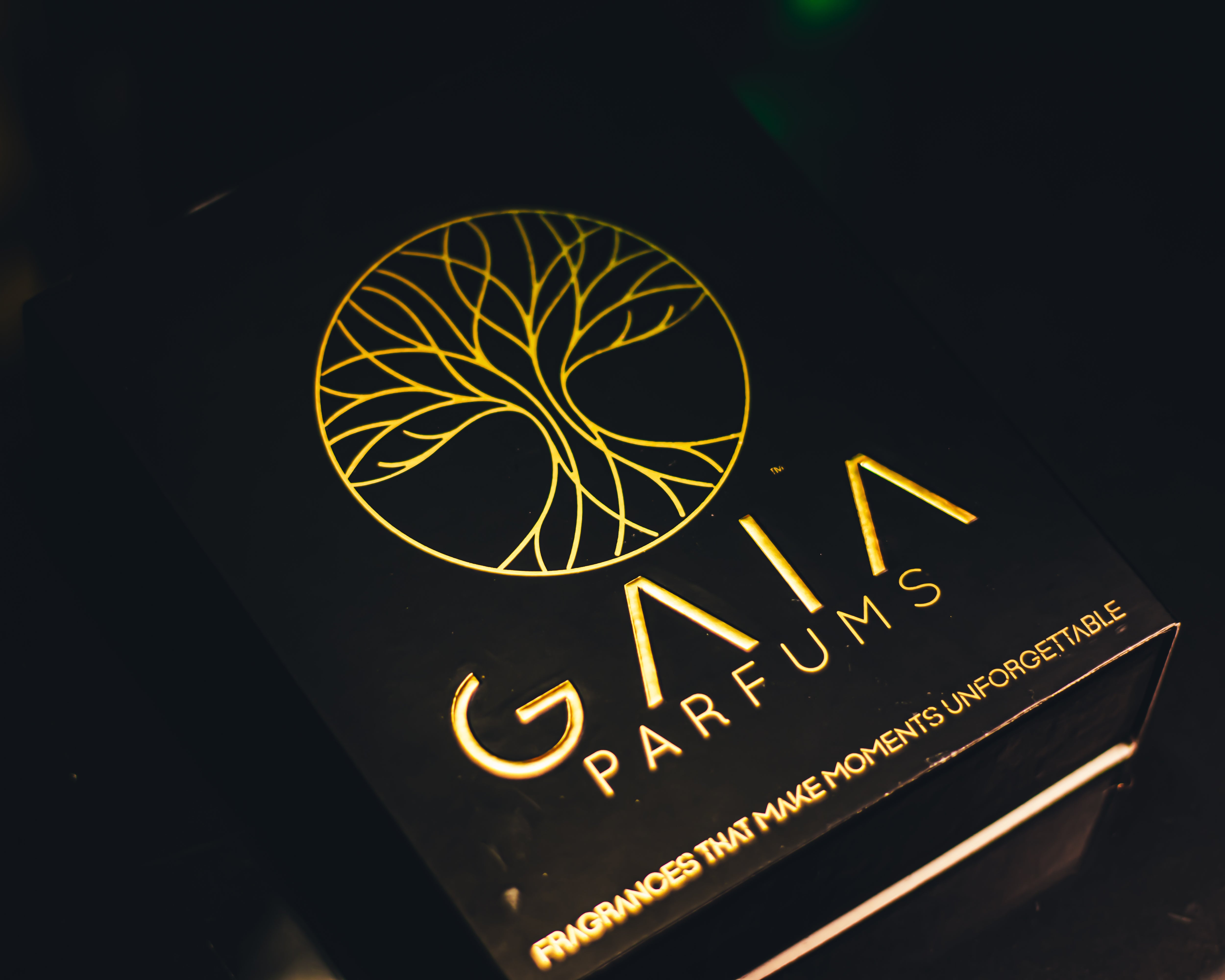 GAIA Parfums packaging with gold logo and text on a dark background