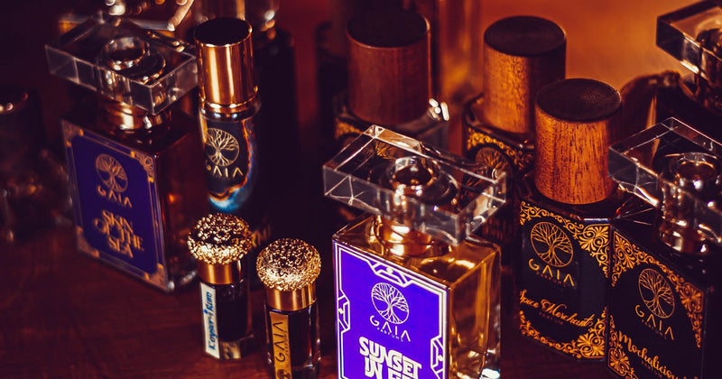 Collection of GAIA Parfums niche perfume bottles with various designs and colors on a wooden surface.